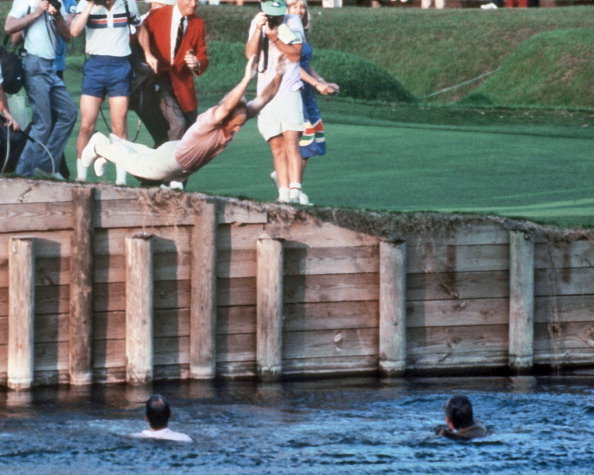 Jerry Pate follows PGA TOUR Commissioner Deane Beman and Course Architect Pete Dye by jumping into the water hazard on the 18th hole after Pate won THE PLAYERS Championship on March 21, 1982.